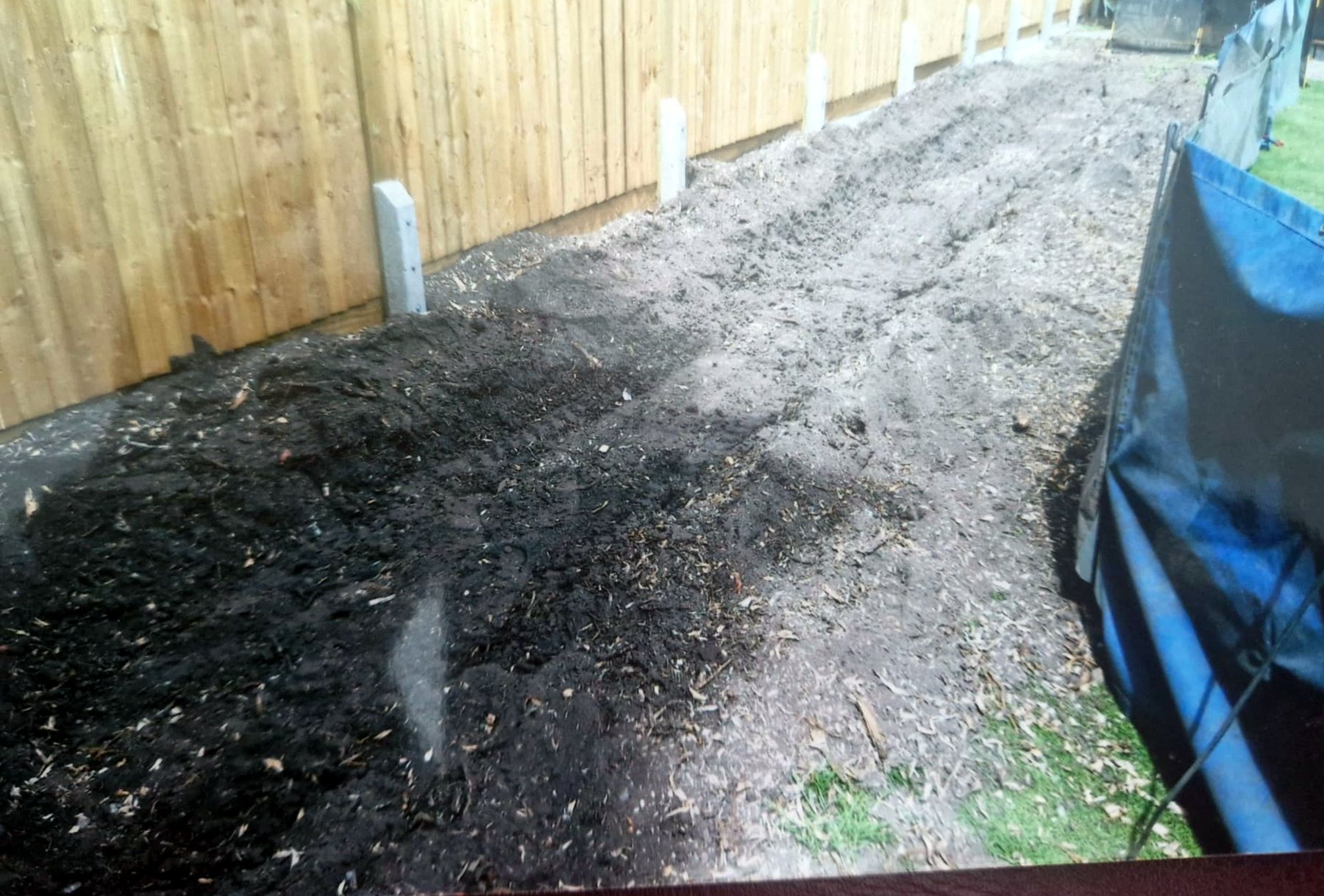 The fence line after grinding, cleared and level